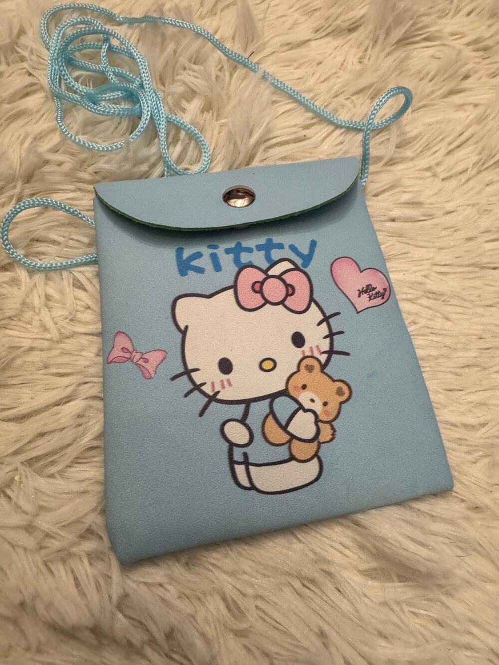 Hello Kitty blue crossbody bag with Hello Kitty holding a teddy bear